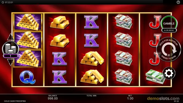 A 5-reel slot game titled Gold Cash Free Spins shows a grid filled with gold bars, stacks of cash, and royal letters K, Q, and J, with a balance of 998.00 and a bet of 1.00.