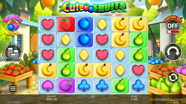 A brightly colored slot game interface titled 'Cute Fruits' displays a 6x5 grid of glossy fruit and card symbols on a light blue background, with a village market scene in the background.