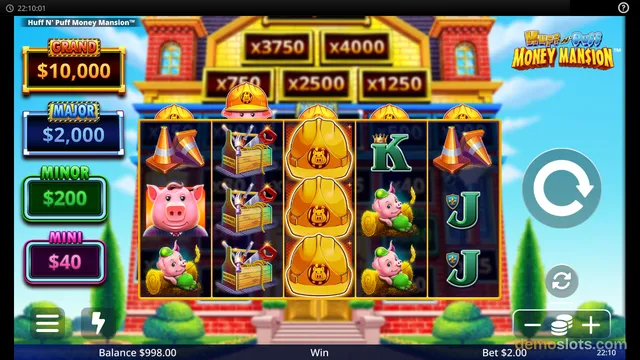 A 5-reel slot game titled Huff N' Puff Money Mansion shows a grid of pig, toolbox, hard hat, and letter symbols with jackpot values on the left and multiplier values above.