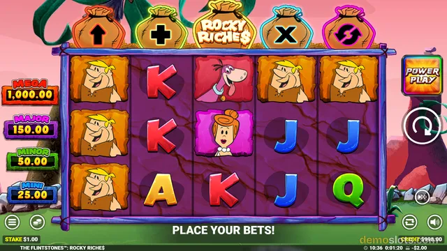 The Flintstones Rocky Riches base game with 5-column reel displaying Fred character, K, Dino, A, J, and Q symbols.