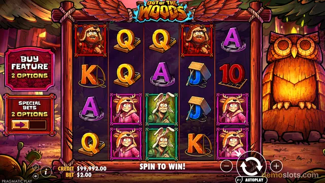 A 5x4 slot game grid titled OUT OF THE WOODS shows cartoon characters in animal hoods and playing card symbols, with a large carved owl statue on the right and a BUY FEATURE panel on the left.