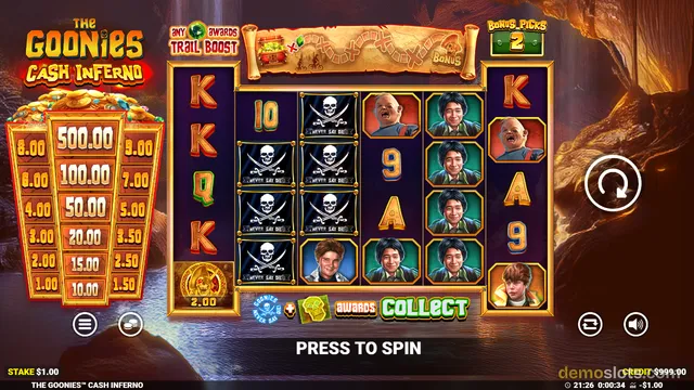 The Goonies Cash Inferno slot game shows a 5-reel grid with symbols including skull and crossbones, character portraits, and card letters, with a trail boost banner at top and a collect ladder on the left.