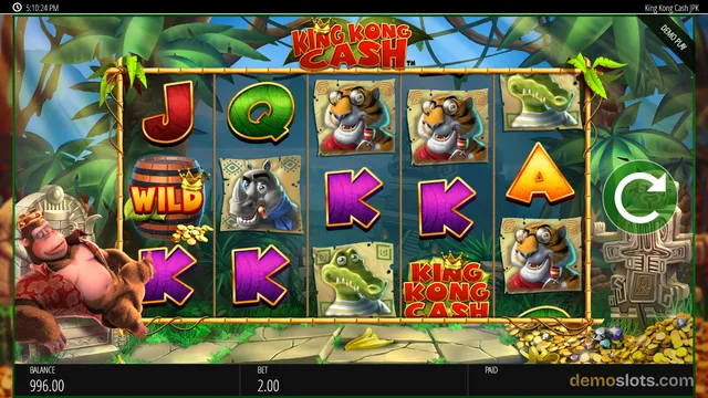 A settled 5x4 reel grid in the King Kong Cash slot game shows a mix of animal and letter symbols, with a large gorilla character on the left side.